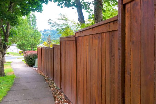 Wooden Fence along suburban neighborhood sidewalk