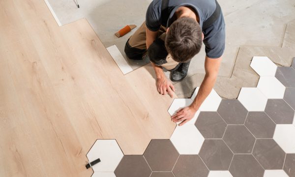 The combination of wood panels of laminate and ceramic tiles in the form of honeycomb. Kitchen renovation.